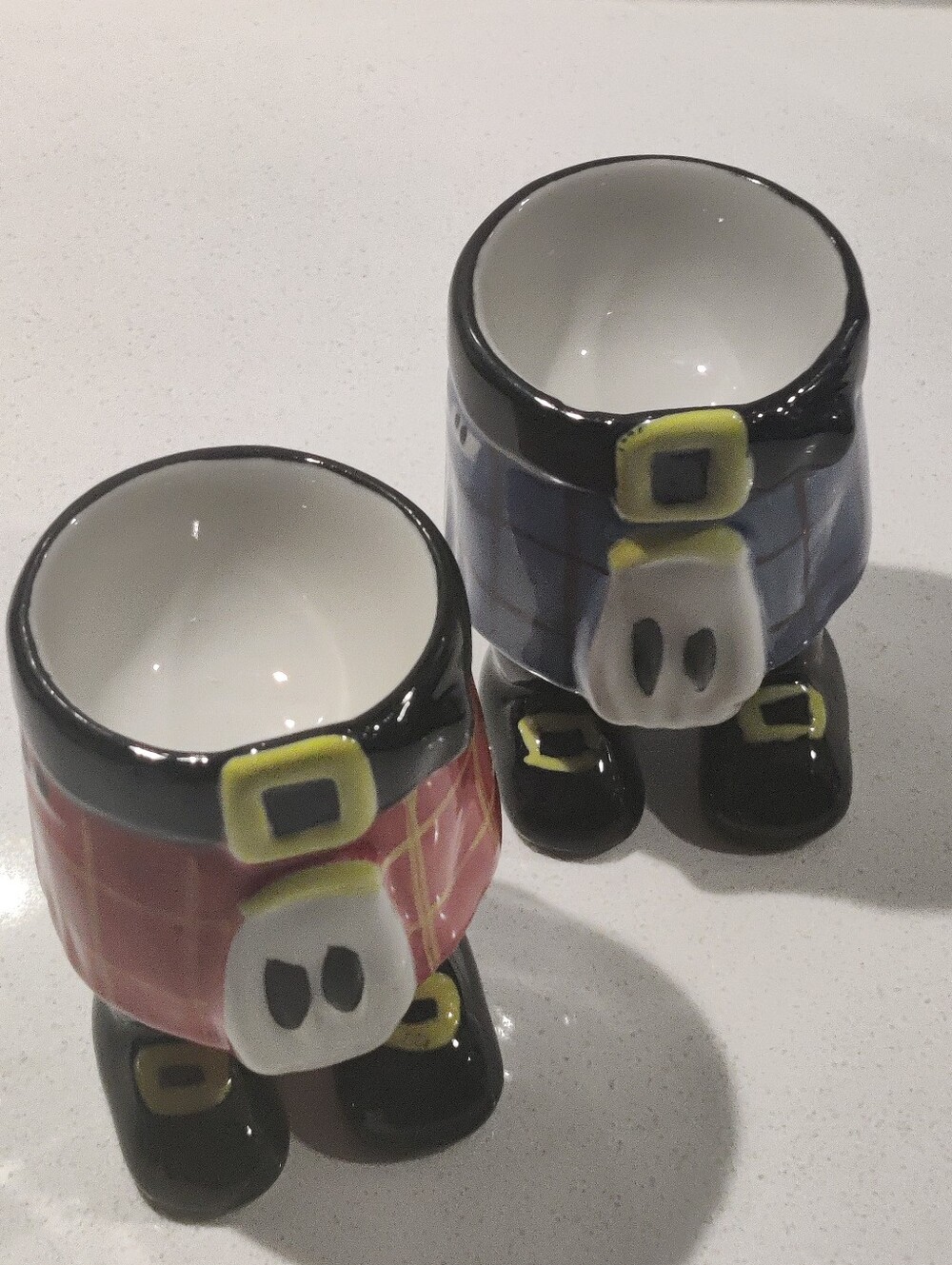 Novelty Ceramic Kilt Two Egg Cups featuring Red and Blue Tartan Designs In